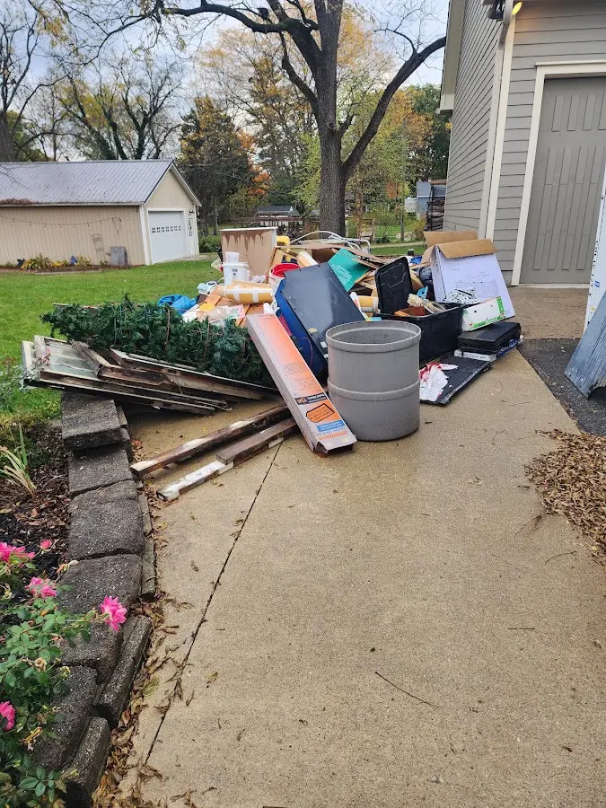 Dumpster being loaded with debris for Estate Cleanout Dumpster Rental in Gretna